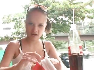 Busty chick in tank top enjoys a meal outdoors