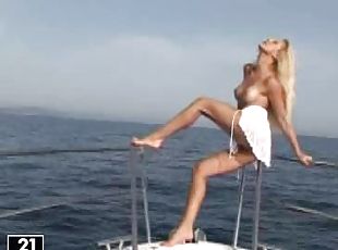 Blonde cutie Sandy plays with her smooth pussy on a yacht