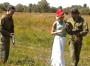 Soldiers tag team a chick while on patrol in a field