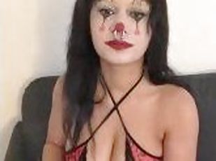 Sexy clown with big tits smokes a cigarette
