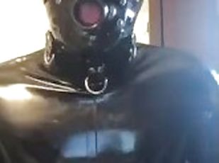 Full rubber gimp shows off suit and jerks off