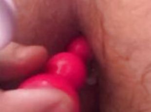 Amateur playing with 2 anal plugs, inserting both at same time in ass.