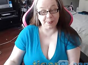 Mature nerdy MILF exposes her huge natural tits on a chair