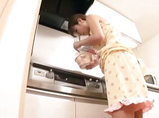 A busty Japanese housewife gets toyed in a kitchen