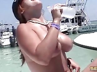 Alluring babes go topless in an out of control boat party