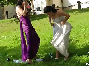 Bride and Maid of Honor Getting Wet With Champagne On The Wedding Day