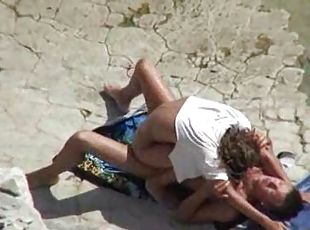 On top of his cock at the beach