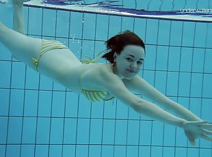 Gorgeous Lada Poleshuk slowly goes nude while swimming around