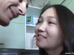 An Asian teen gets her shaved pussy fucked in a kitchen