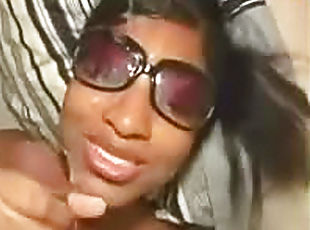Black babe in sunglasses jacks off a cock
