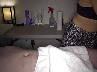 Clothed masseuse chick gives an unforgettable handjob on table