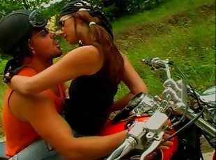 Biker with a babe on his bike fills her fuck hole with cock