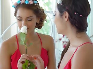 Stunning women with flowers in their hair enjoy a lesbian game