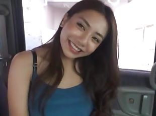 Japanese brunette moans while being pleasured in the car